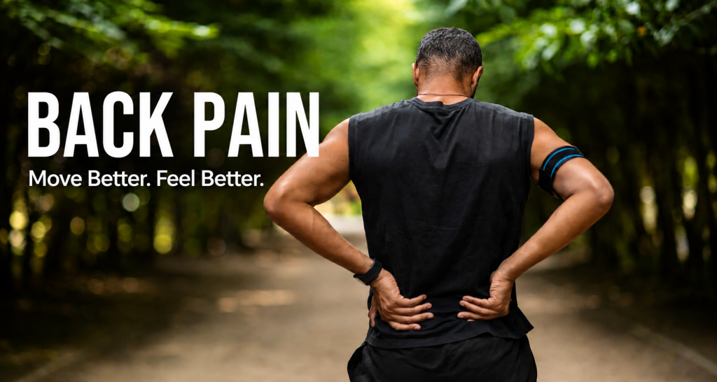 Man experiencing back pain while standing outdoors with his hands on his back.
